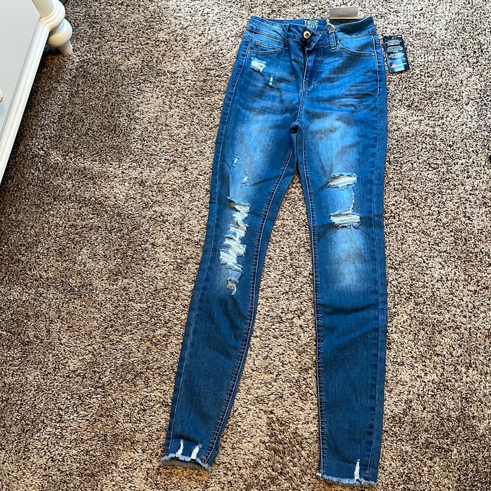 Woman’s distressed ripped skinny high rise jeans